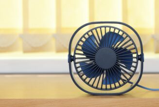 small-usb-fan-table-against-background-yellow-blinds-min