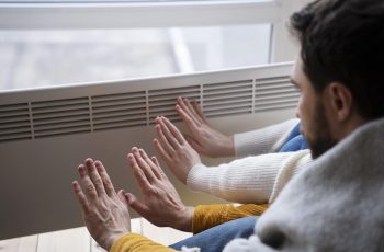 people-warming-up-their-hands-with-heater-min